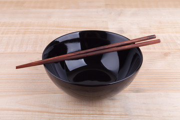 Chopsticks in asian set table on wood background