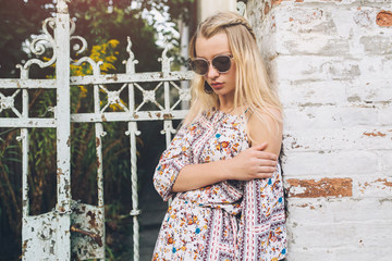 Obraz premium Stylish hippie girl walking down the street and enjoying life.