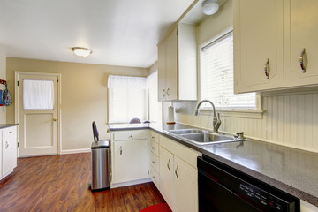 Simple white kitchen room interior with hardwood floor.