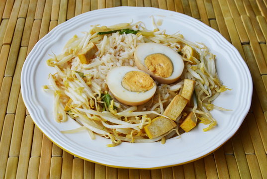 boiled brown egg and stir fried bean sprout with yellow tofu on rice