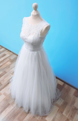 Fototapeta na wymiar Beautiful wedding dress on floor beside wall