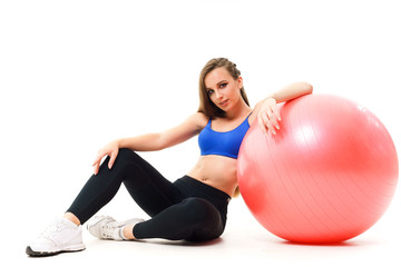Fototapeta na wymiar Concepts: healthy lifestyle, sport. Happy beautiful woman fitness trainer working out with fit ball isolated on white background