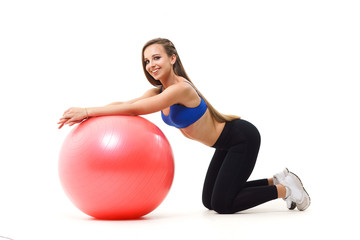 Fototapeta premium Concepts: healthy lifestyle, sport. Happy beautiful woman fitness trainer working out with fit ball isolated on white background