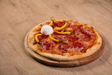 Pizza served on wooden board