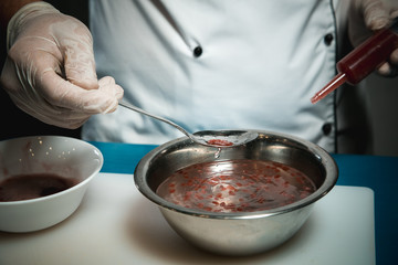Cheerful bearded chef cook cooking while cooking meals in the kitchen