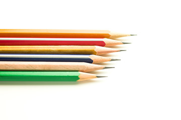 Pencils of different colors are on white.