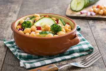 Chickpea salad isolated on wooden background

