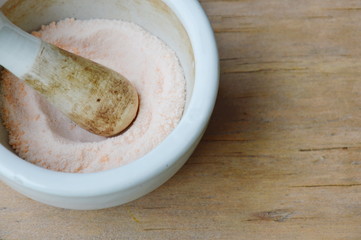 mortar and pestle for crushed pill on wooden board
