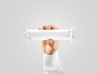 Blank white candy bar plastic wrap mock up holding in hand, clipping path. Clear chocolate bar packaging template. Choco factory logo branding candybar package mock up. Pastry shop energy bar cover