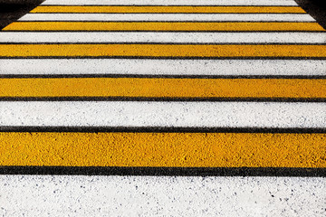 pedestrian crossing. stripes of white and yellow.