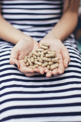 Obraz premium Girl holding natural pills