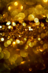 Defocused glitter vintage lights background with dark gold and b