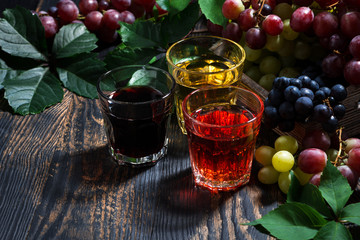assortment of grape juice on wooden background