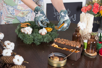 Christmas decoration accessories on wooden table, woman at backg