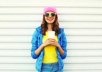 Fashion pretty smiling woman with coffee cup in colorful clothes