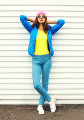 Obraz premium Fashion pretty woman model in colorful clothes posing over white