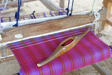wooden bobbin on ancient silk loom