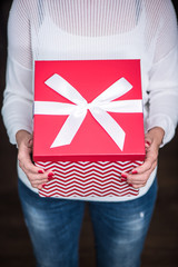woman hands hold big Christmas gift box present