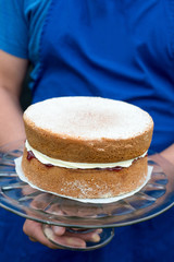 a victoria sponge cake on glass cake stand