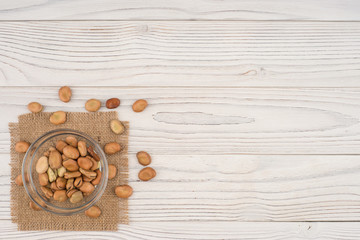Beans in a glass bowl on the old wooden table.