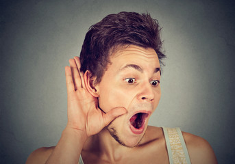 Surprised nosy man hand to ear gesture carefully listening gossip