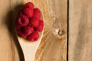 Rasberries on wooden spoon