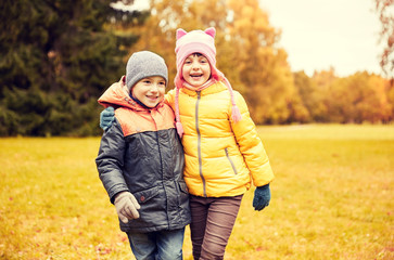 happy little girl and boy in autumn park