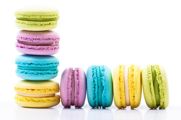 Collection of brightly colored French macarons on white backgrou