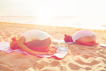 couple making yoga exercises outdoors