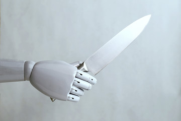 artificial intelligence hand holding a knife
