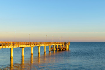 Fototapeta premium A wooden pier of the city Zelenogradsk in the Baltic sea