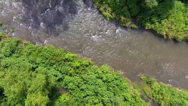 Mountain river and green riverbank from above.