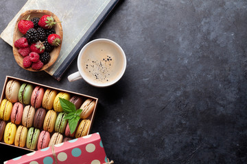 Colorful macaroons, berries and coffee