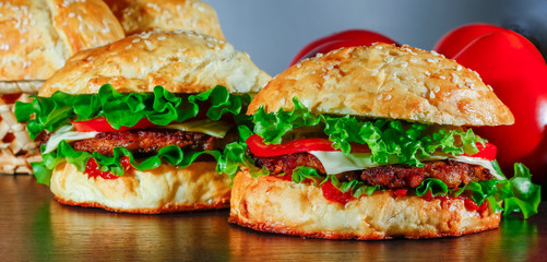 Close-up of home made tasty burgers on wooden table
