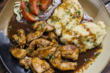 chicken breast with brown gravy sauce and mashed potato