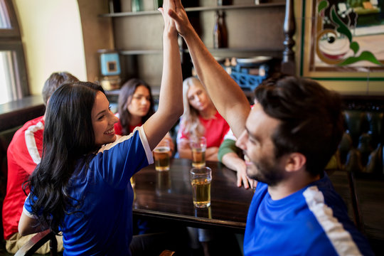 Football Fans With Beer Celebrating Victory At Bar