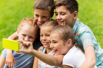 happy kids or friends taking selfie in summer park