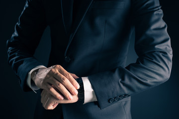 Businessman checking time from watch