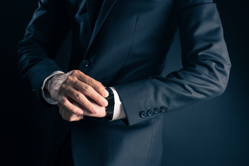 Businessman checking time from watch