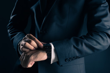 Businessman checking time from watch