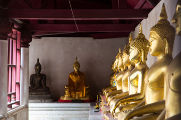 Buddha meditating under a roof.