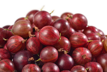 Heap of fresh red gooseberry close up on a white