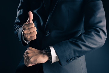 Businessman checking time from watch