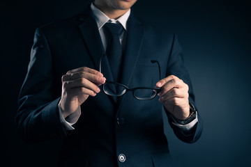 Businessman Pick Glasses: Isolated Black Background