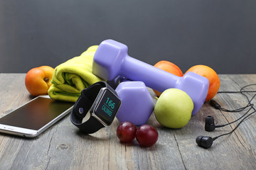 healthy lifestyle dumbbell smart watch and fruit
