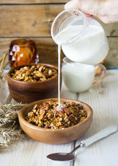 Healthy granola with nuts and milk for breakfast
