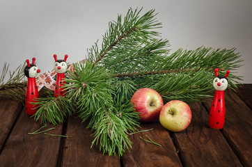 Festive composition of pine branches, apples, toys