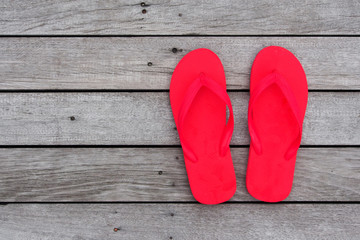 Red beach sandals on wooden background