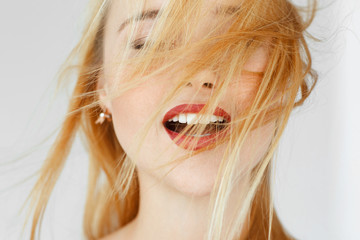 Enjoying something red-haired woman, close up. Portrait of carroty female adult with closed eyes....