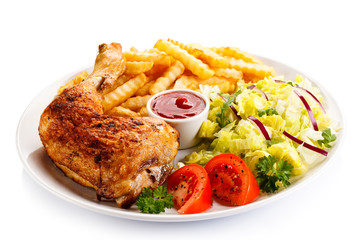 Grilled chicken legs with chips and vegetables 